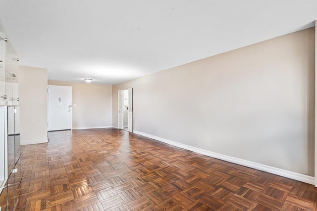 unfurnished room featuring baseboards