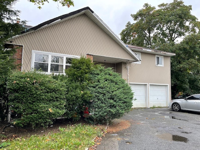 view of home's exterior with driveway and an attached garage