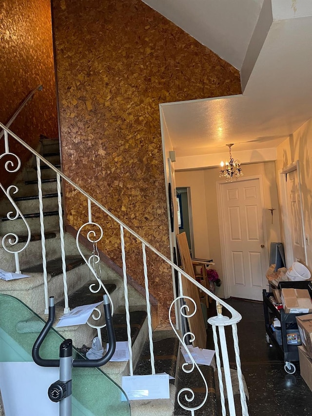 stairway with an inviting chandelier