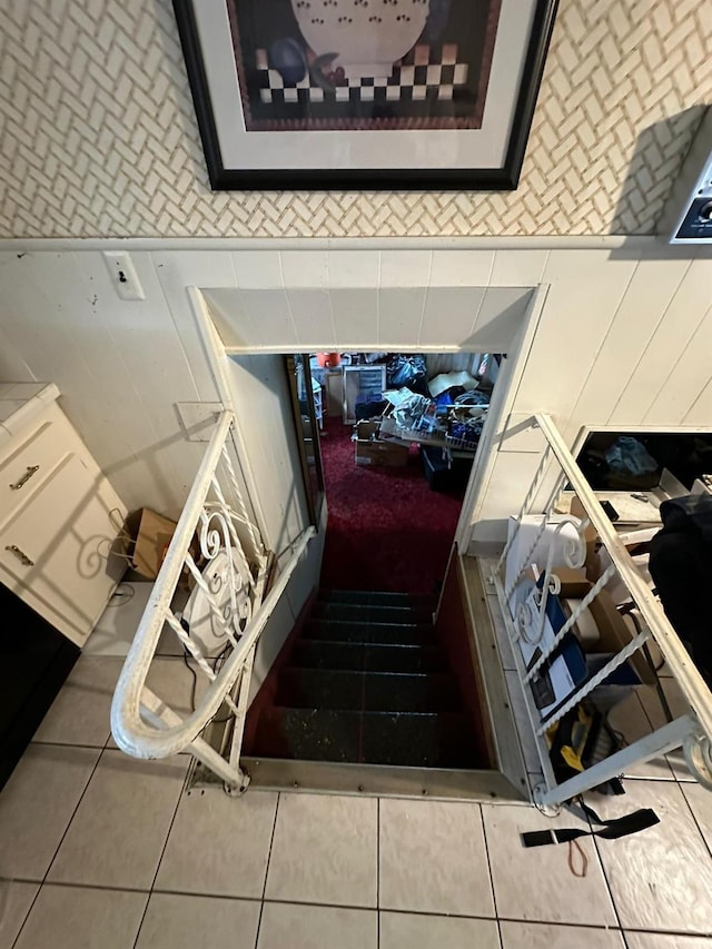 stairway featuring tile patterned flooring