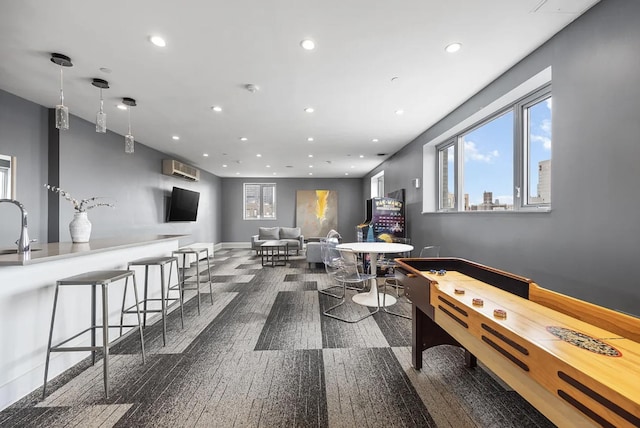 game room featuring recessed lighting and a sink