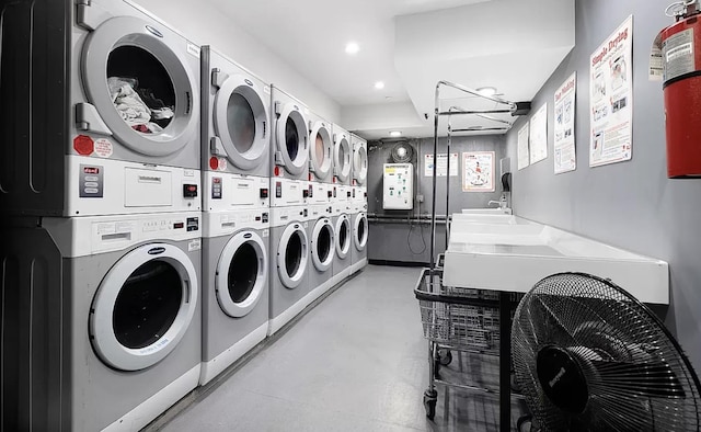 common laundry area with recessed lighting, independent washer and dryer, and stacked washing maching and dryer