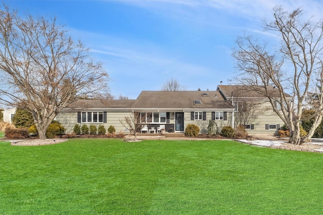 back of house featuring a lawn and a porch