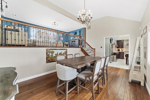 dining area with stairway, baseboards, lofted ceiling, wood-type flooring, and a chandelier