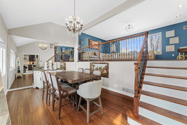 dining space featuring visible vents, wood-type flooring, a chandelier, and stairs