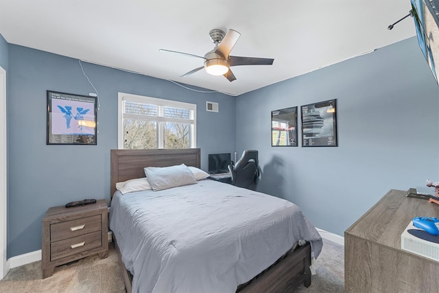 bedroom featuring visible vents, a ceiling fan, baseboards, and carpet floors