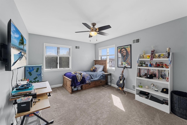 carpeted bedroom with visible vents, baseboards, and ceiling fan