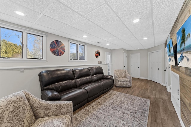 living area with recessed lighting, baseboards, and wood finished floors