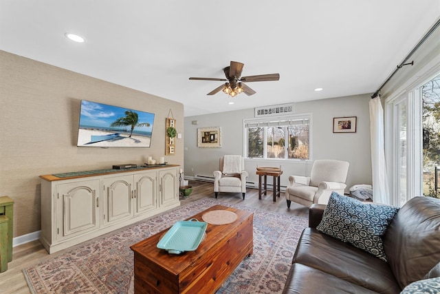 living room featuring recessed lighting, light wood-style floors, baseboards, and ceiling fan