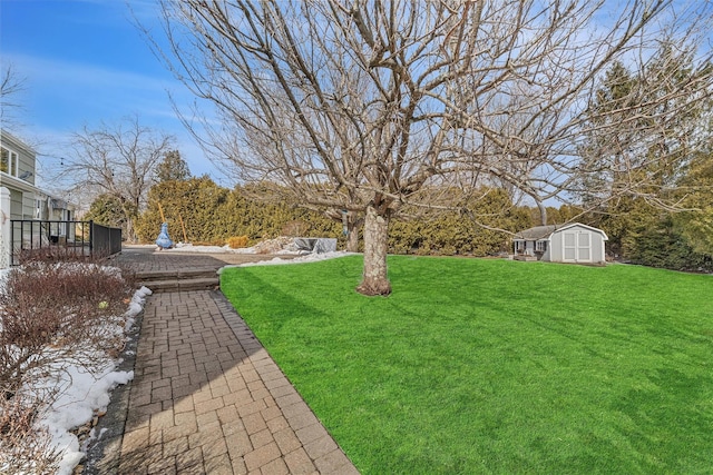 view of yard with a storage shed and an outdoor structure