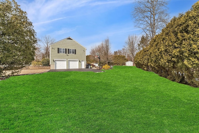 exterior space with a lawn, driveway, and a garage