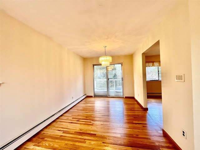 unfurnished dining area with baseboards, light wood-type flooring, baseboard heating, and a chandelier