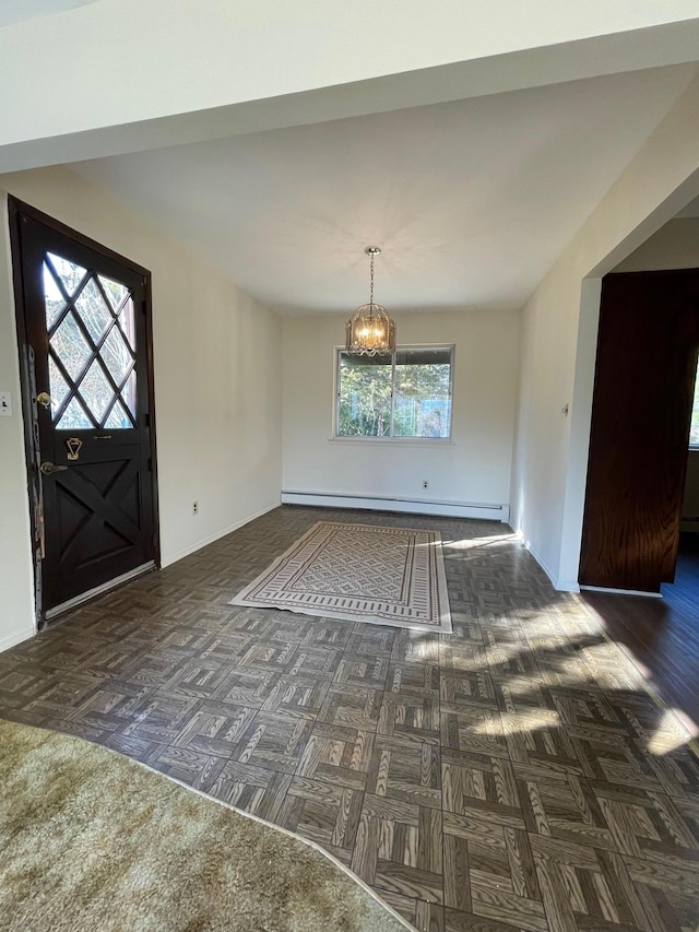 entrance foyer featuring a notable chandelier, baseboards, and a baseboard radiator