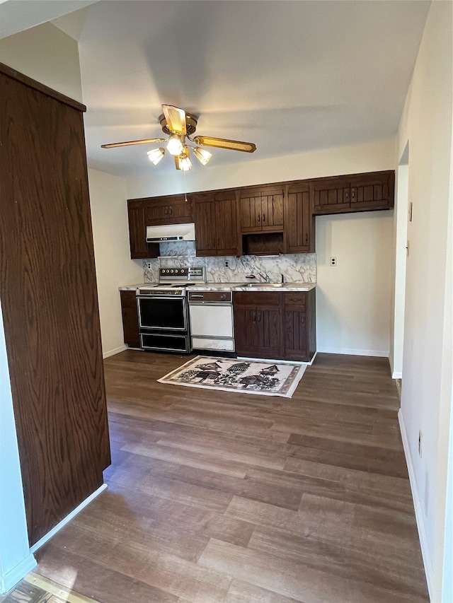 kitchen with electric range, white dishwasher, dark brown cabinets, under cabinet range hood, and backsplash