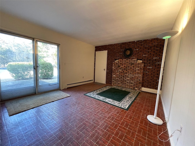 interior space featuring a baseboard heating unit, brick patterned floor, and brick wall