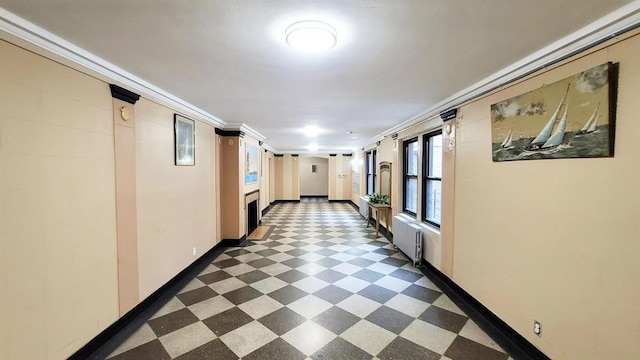 hallway with baseboards, dark floors, radiator heating unit, and crown molding