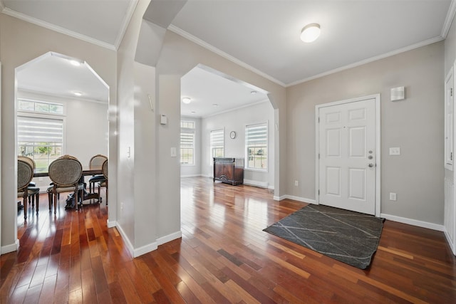 foyer featuring arched walkways, baseboards, and dark wood-style floors