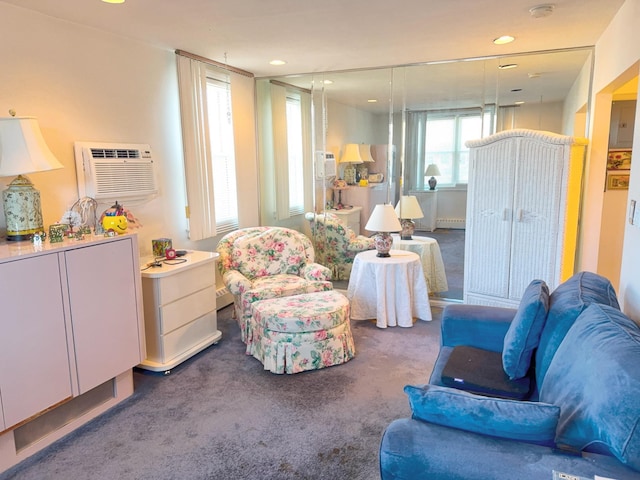 living area featuring an AC wall unit, carpet flooring, and recessed lighting