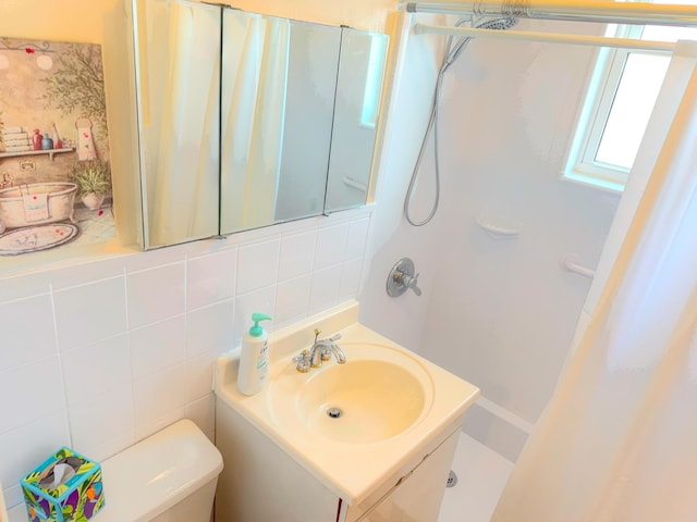 full bath with vanity, decorative backsplash, walk in shower, tile walls, and toilet