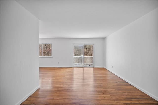 unfurnished room featuring baseboards and wood finished floors