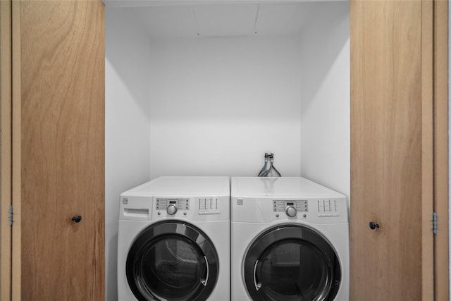 washroom featuring washer and clothes dryer and laundry area