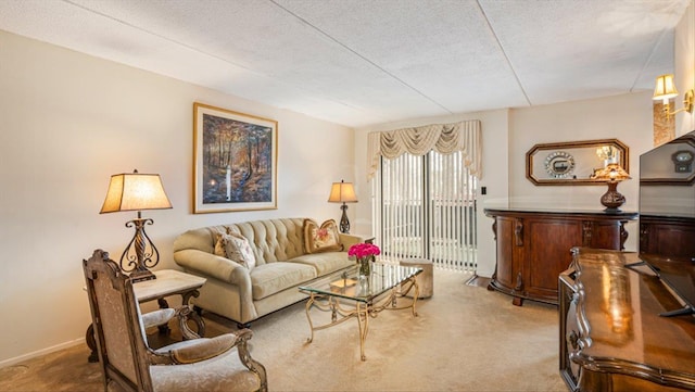 carpeted living area featuring a textured ceiling and baseboards