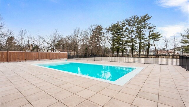 view of swimming pool with a fenced in pool, a fenced backyard, and a patio area