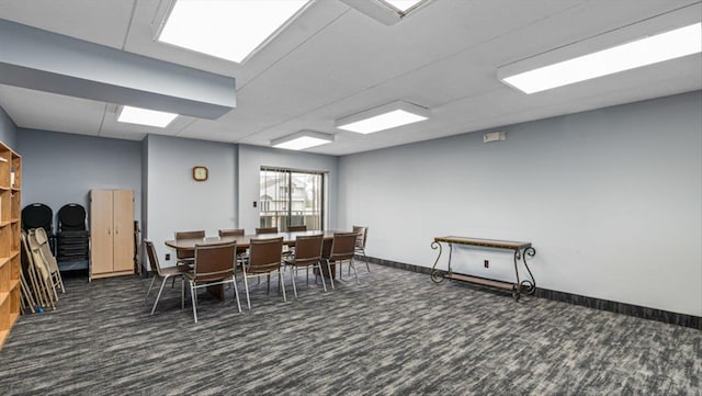 carpeted dining area with baseboards