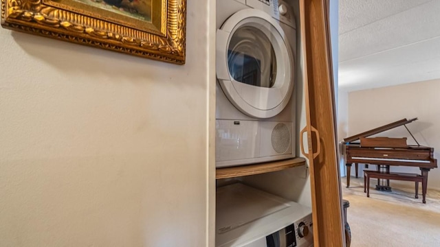 washroom featuring carpet flooring, stacked washer and clothes dryer, and laundry area