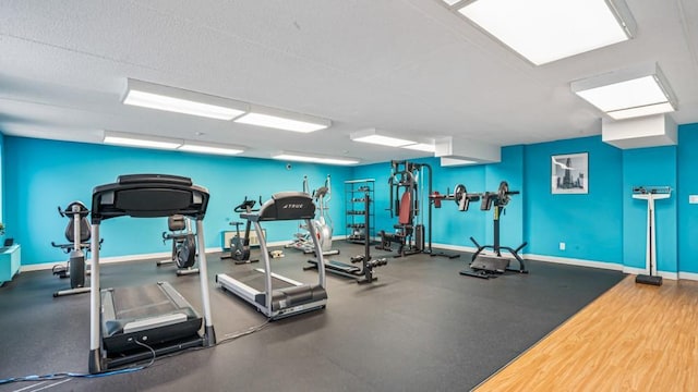 gym with baseboards and a textured ceiling