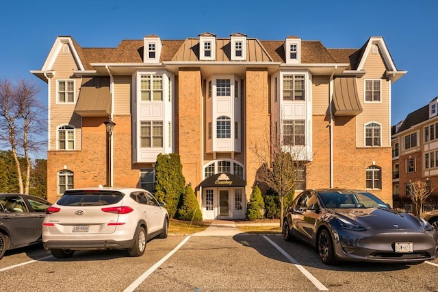 view of building exterior featuring uncovered parking