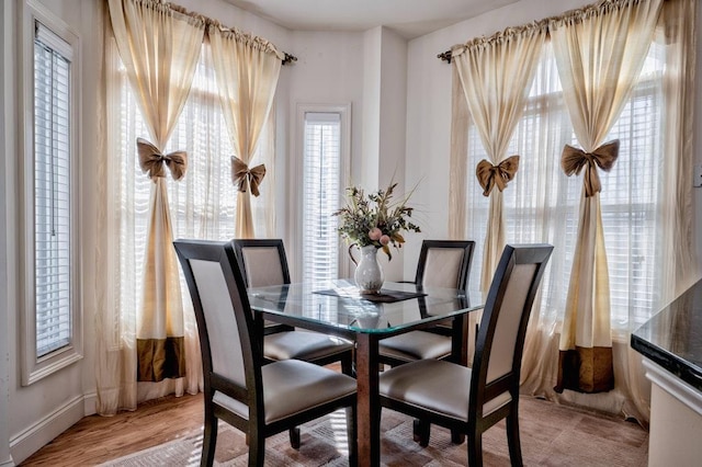 dining space with light wood finished floors