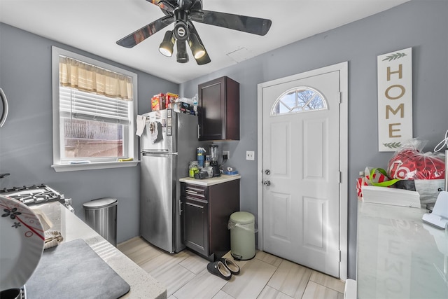 kitchen with ceiling fan, light countertops, and freestanding refrigerator