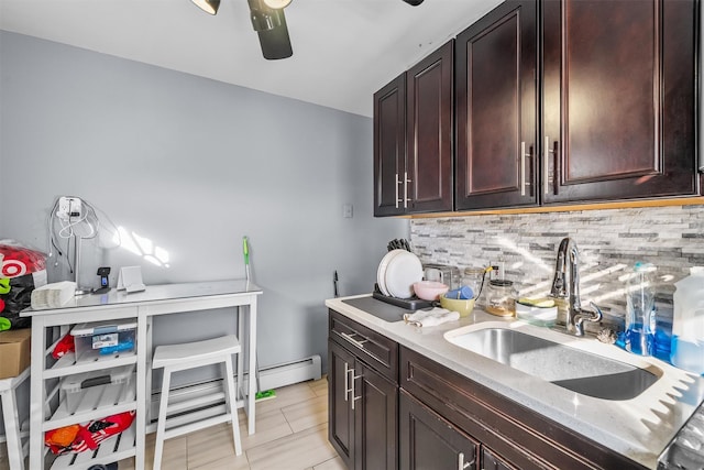 kitchen featuring a ceiling fan, a sink, light countertops, dark brown cabinetry, and backsplash