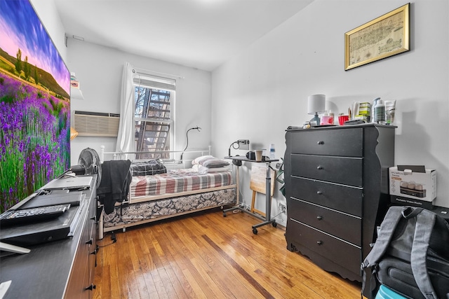 bedroom with hardwood / wood-style flooring