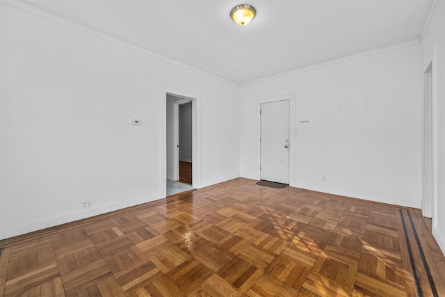 spare room featuring crown molding and baseboards