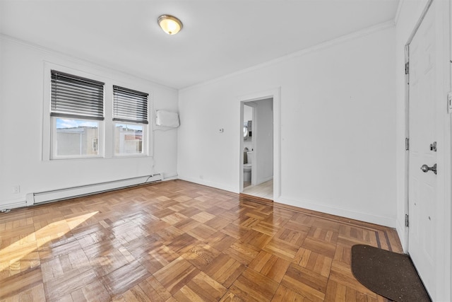 empty room featuring baseboard heating, crown molding, and baseboards