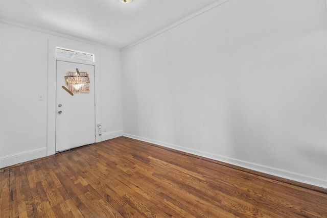 empty room with dark wood-type flooring and baseboards