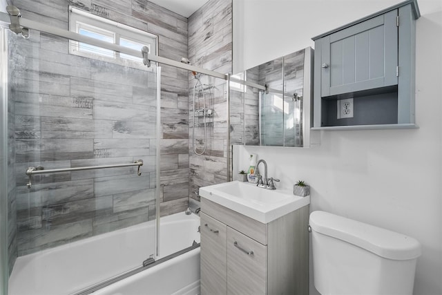 full bathroom with vanity, toilet, and bath / shower combo with glass door