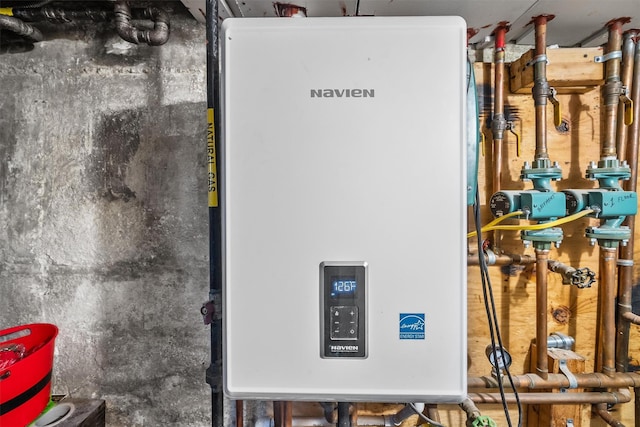 utility room featuring tankless water heater