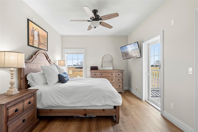 bedroom featuring baseboards, light wood-style floors, ceiling fan, and access to outside