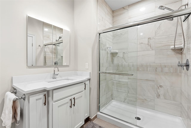 bathroom featuring a stall shower and vanity