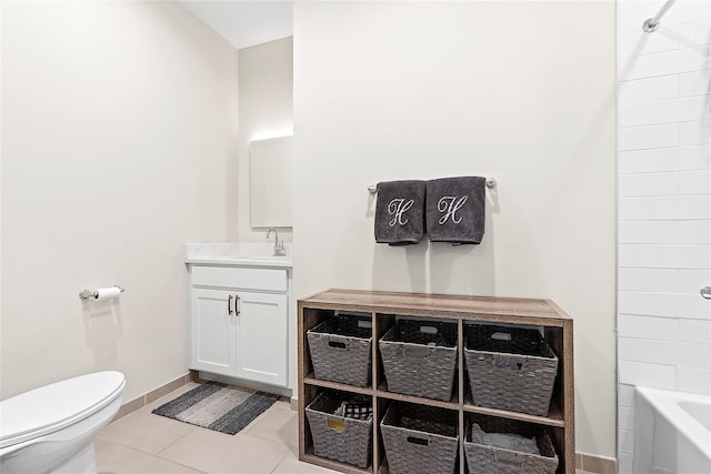 full bath featuring tile patterned flooring, toilet, vanity, and baseboards