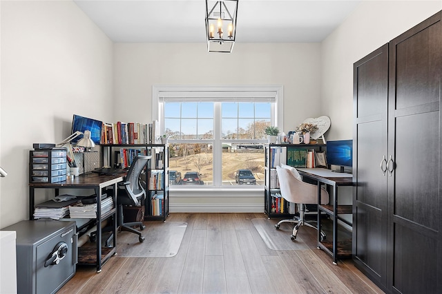 home office with wood finished floors and a chandelier