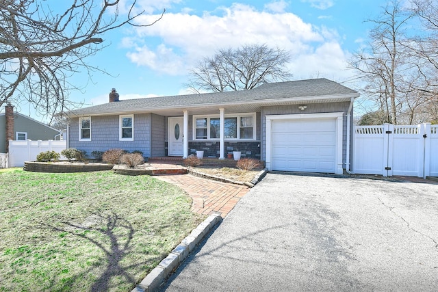 ranch-style home featuring a gate, aphalt driveway, fence, an attached garage, and a chimney