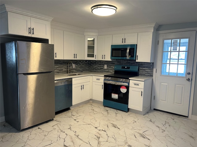 kitchen with marble finish floor, a sink, appliances with stainless steel finishes, white cabinets, and light countertops