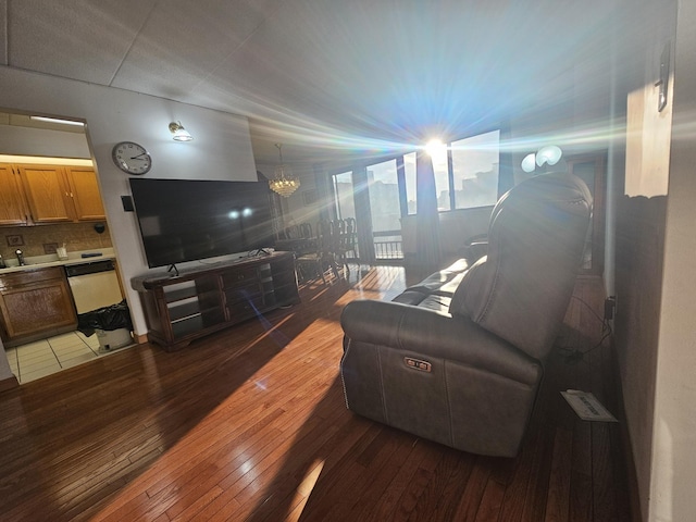 living room with wood-type flooring and a notable chandelier