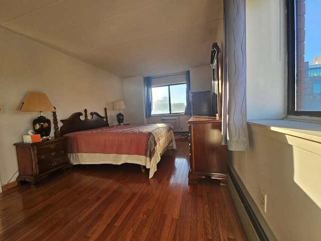 bedroom with dark wood finished floors