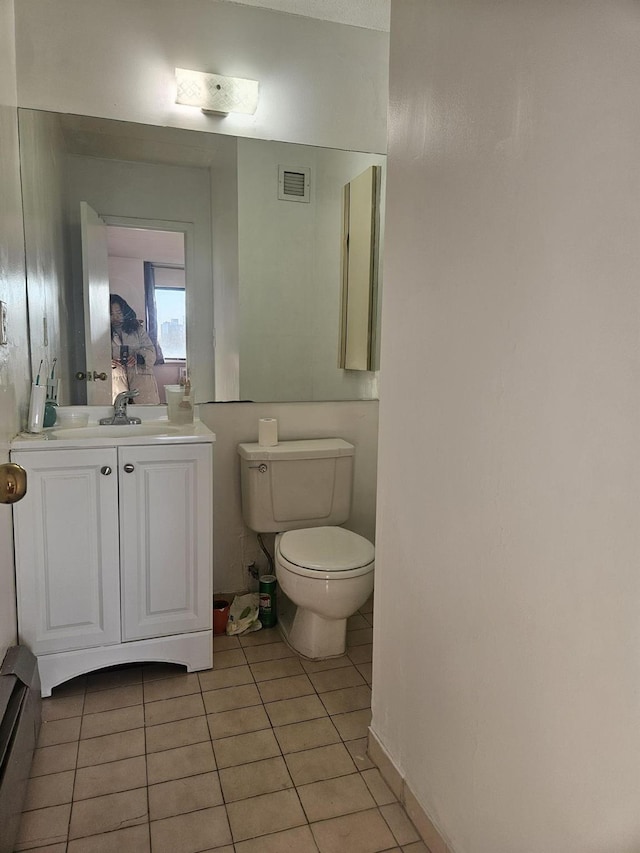 half bathroom with tile patterned flooring, visible vents, toilet, and vanity