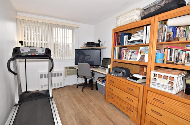 home office featuring radiator heating unit and light wood-style floors